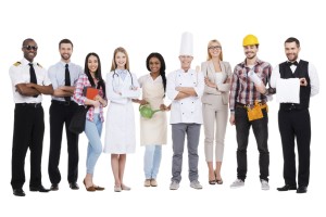 Choose your profession. Group of diverse people in different occupations standing close to each other and against white background and smiling
